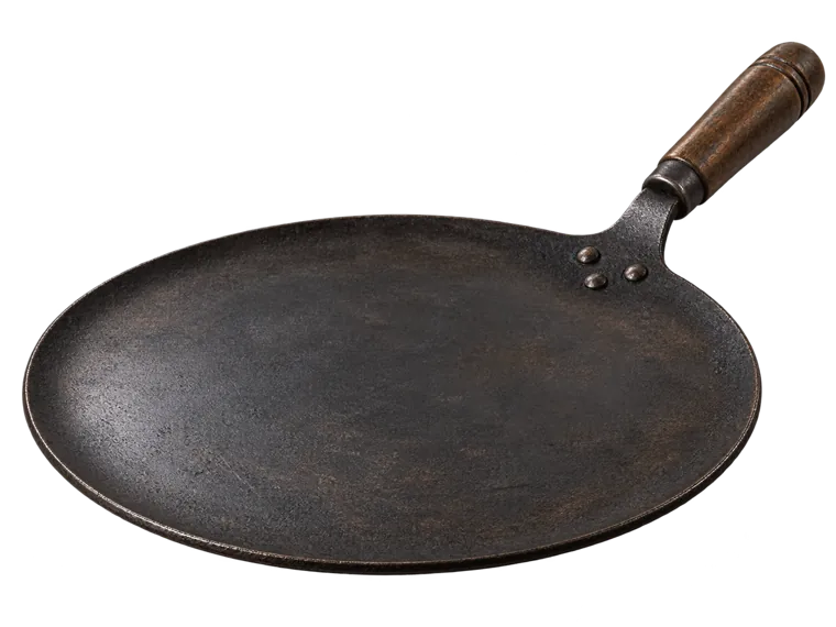 Fresh Roti puffed above a traditional iron tawa